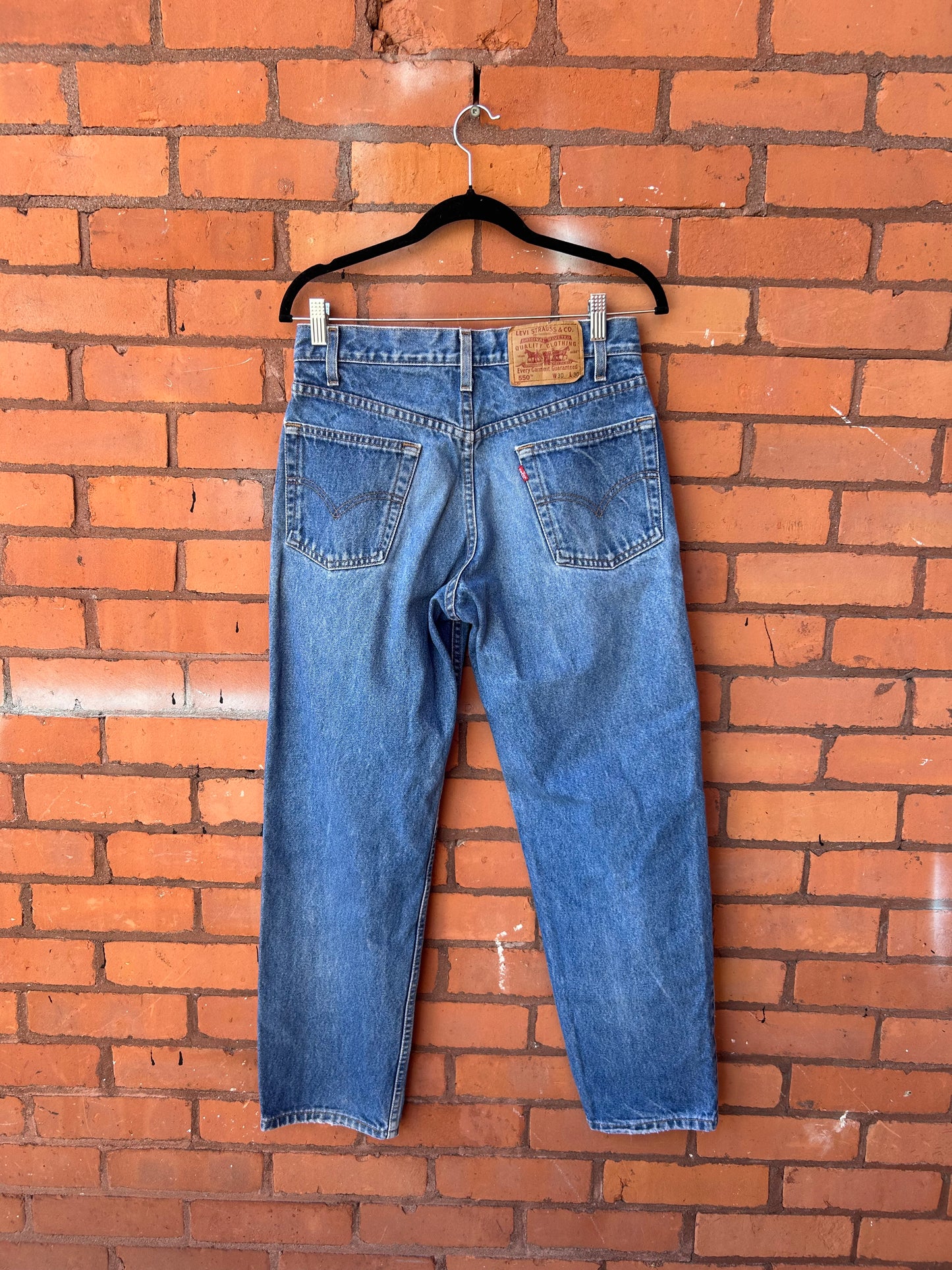 90’s Vintage Levi’s 550 Faded Blue Relaxed Fit Jeans / 30 Waist
